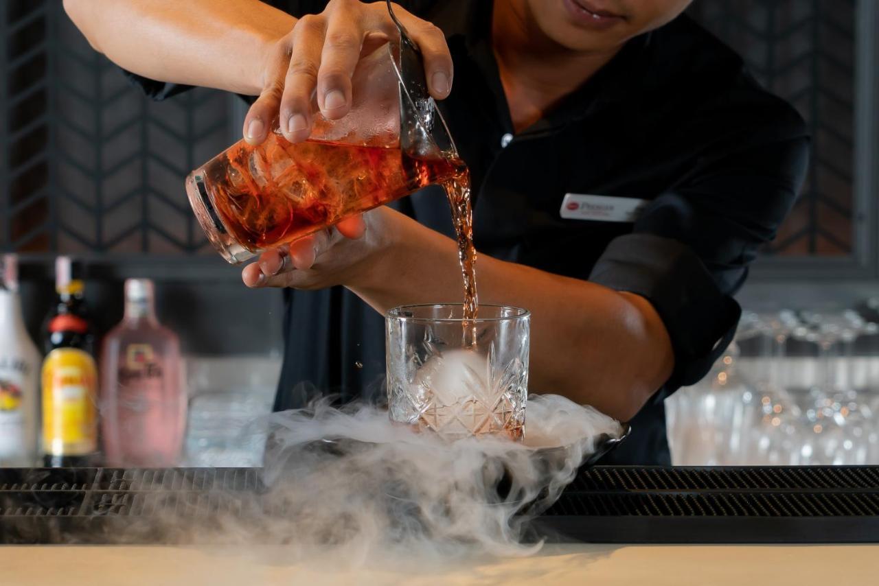 Bayphere Hotel Pattaya Jc Na Chom Thian Buitenkant foto A bartender pouring a cocktail